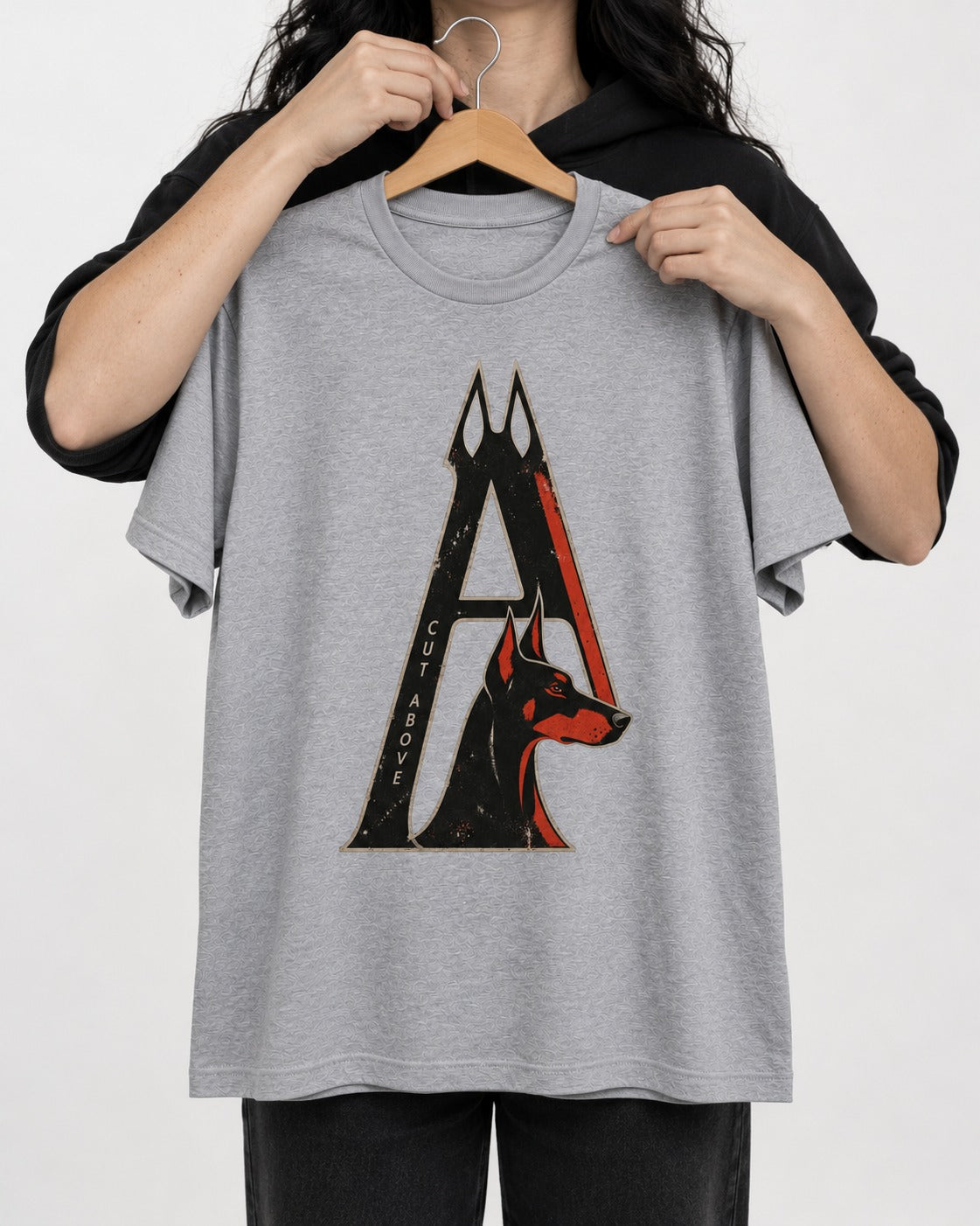 Doberman A Cut Above T-Shirt in Sport Grey, held up on a hanger