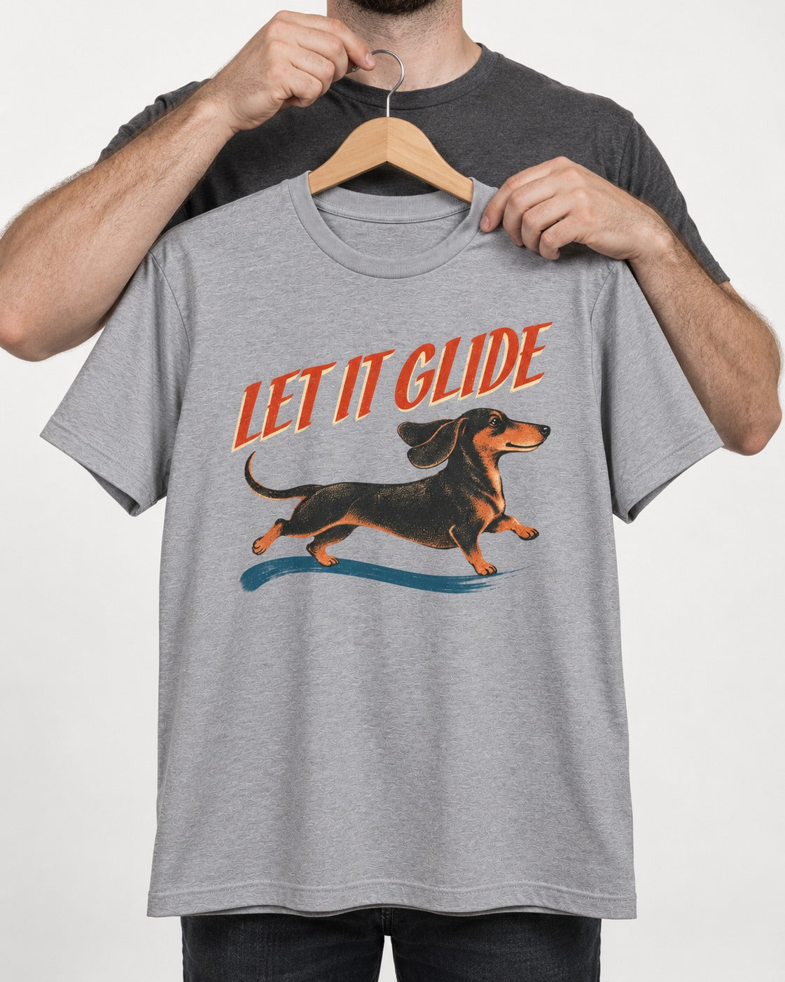 Let It Glide Dachshund T-Shirt in Sport Grey, held up on a hanger