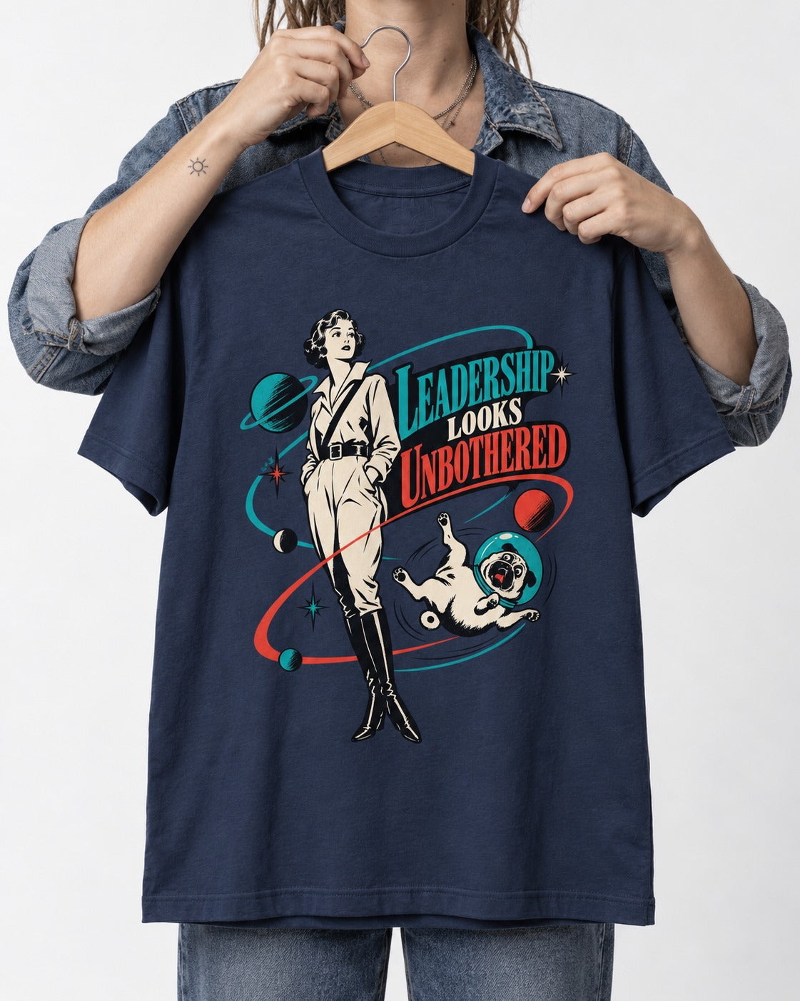 Pug Leadership Looks Unbothered Space Graphic T-Shirt in Navy, held up on a hanger