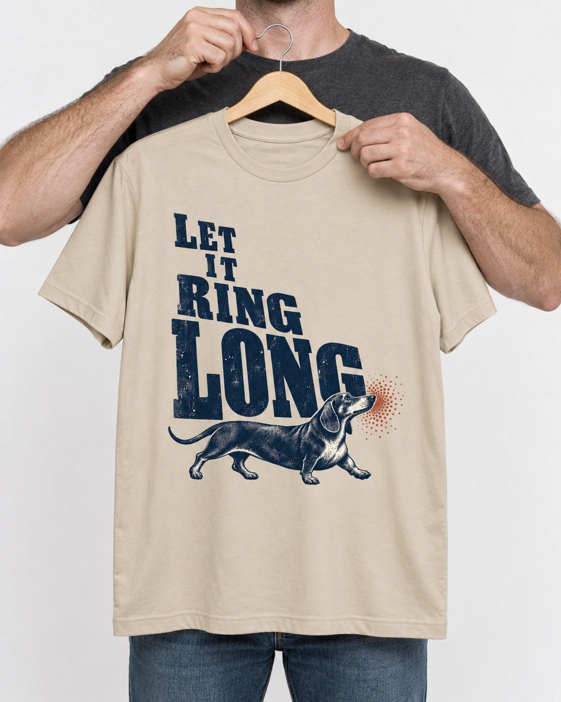 Let It Ring Long Dachshund T-Shirt in Sand, held up on a hanger