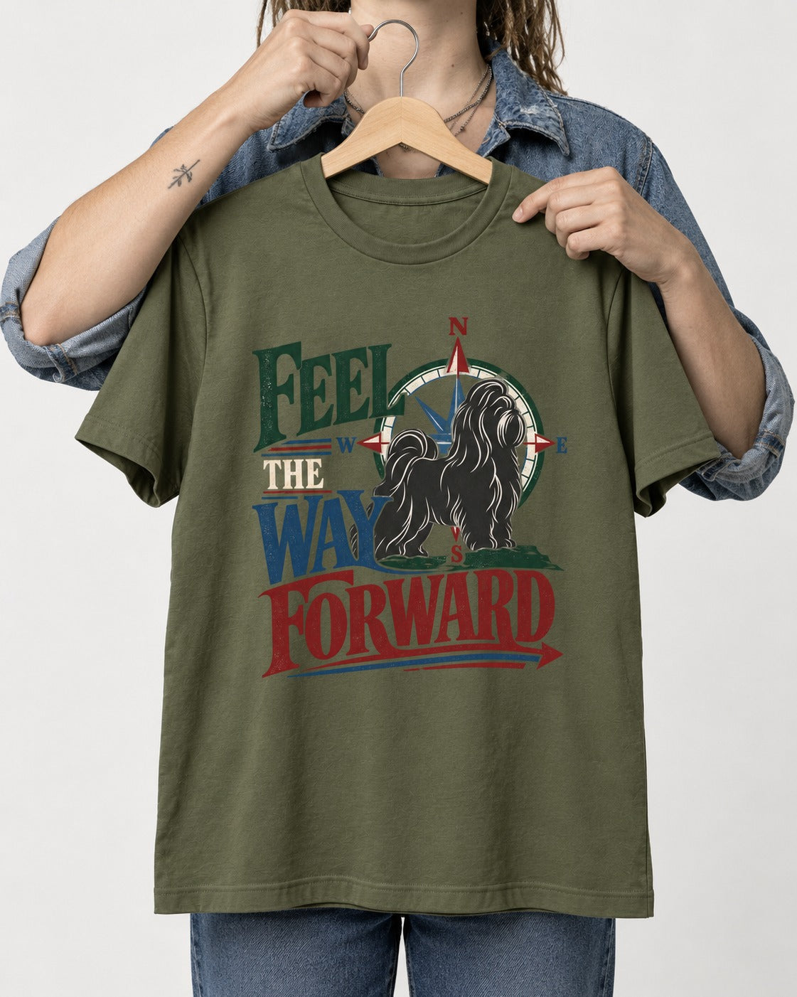 Shih Tzu Feel the Way Forward Compass Graphic T-Shirt in Heather Military Green, held up on a hanger