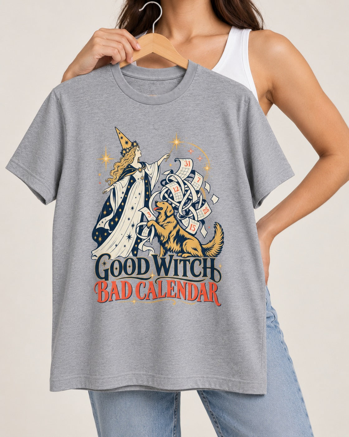 Good Witch Bad Calendar Golden Retriever T-Shirt in Sport Grey, held up on a hanger