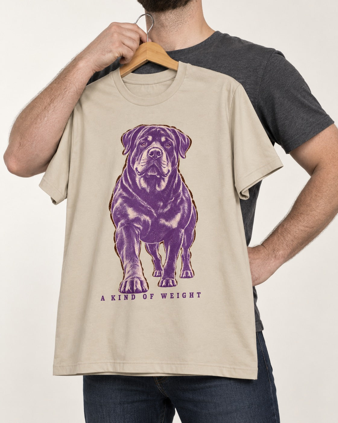 Rottweiler A Kind of Weight T-Shirt in Sand, held up on a hanger