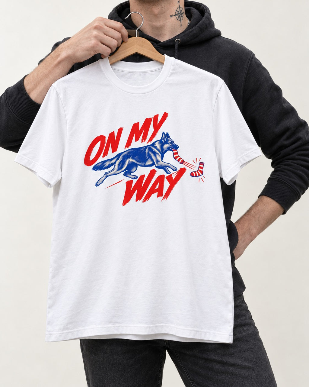 German Shepherd Dog On My Way Sock Chase Graphic T-Shirt in White, held up on a hanger