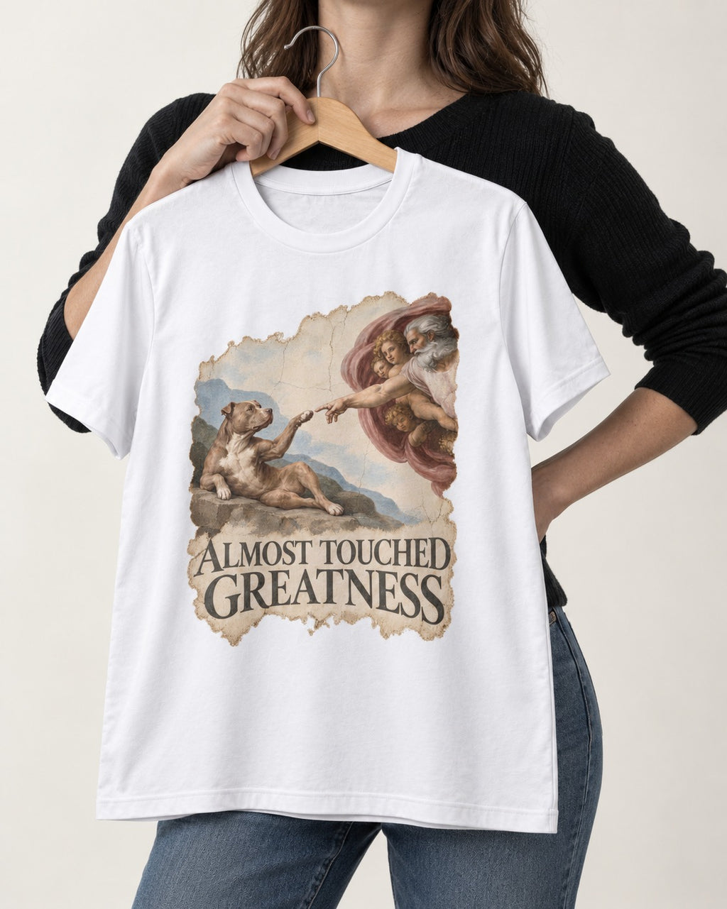 Pitbull Almost Touched Greatness Creation Parody Graphic T-Shirt in White, held up on a hanger