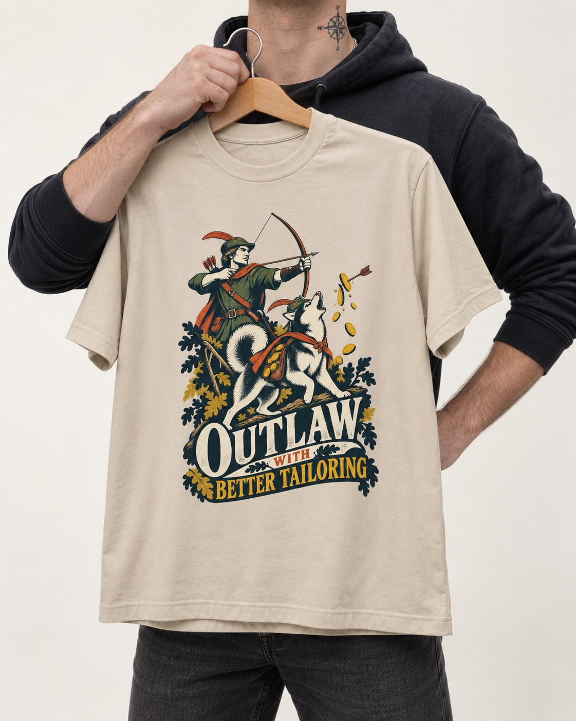Husky Outlaw with Better Tailoring T-Shirt in Sand, held up on a hanger
