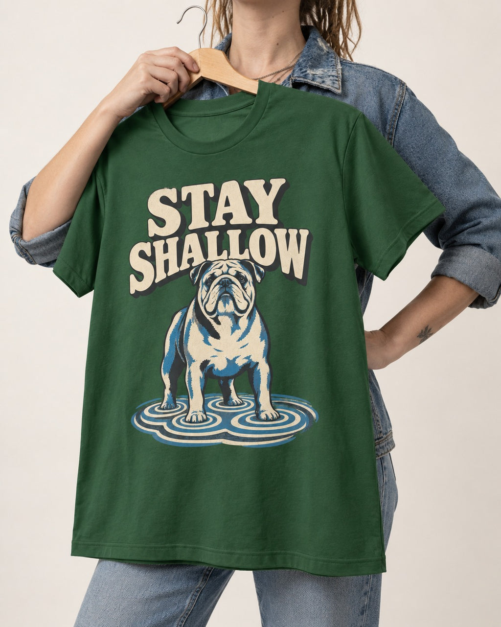 English Bulldog Stay Shallow Ripple Graphic T-Shirt in Forest Green, held up on a hanger