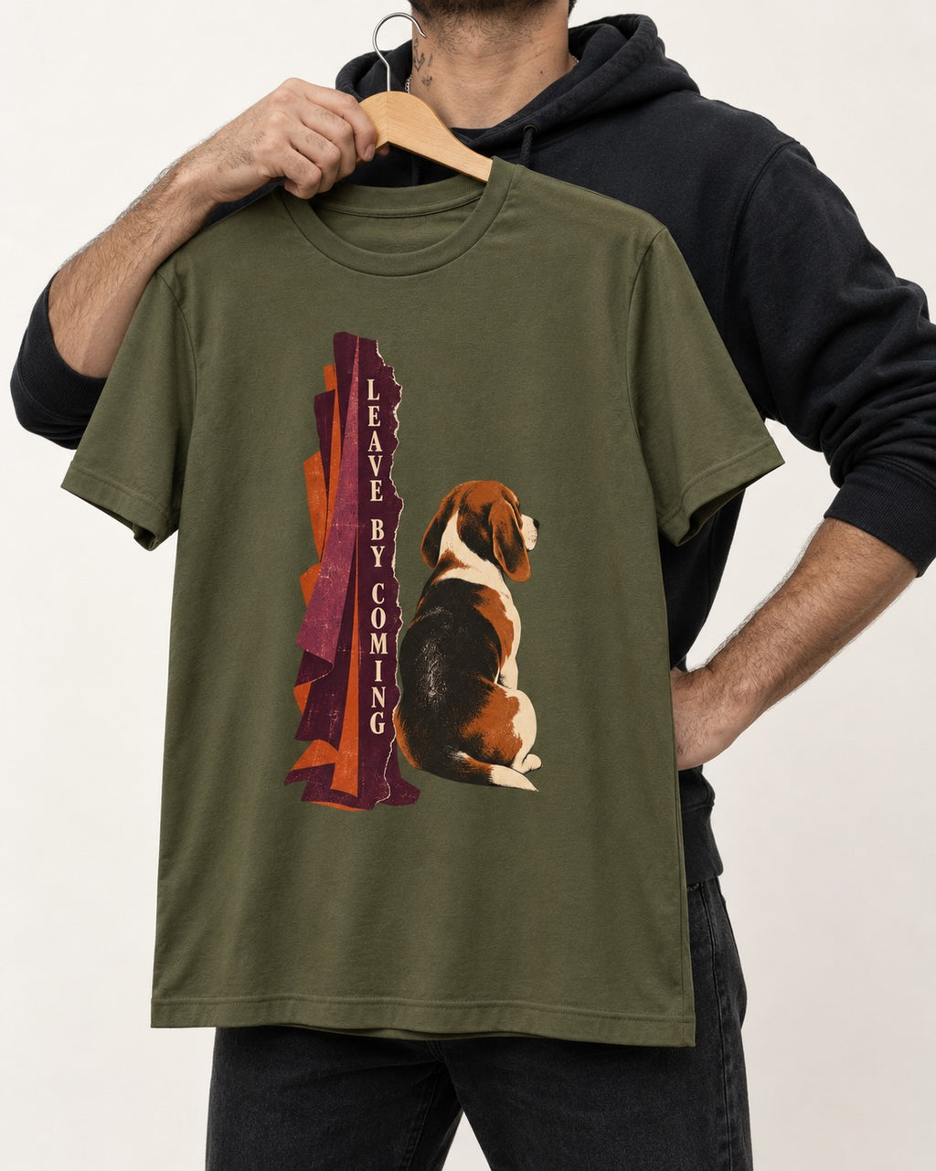 Leave By Coming Beagle Companion T-Shirt in Heather Military Green, held up on a hanger