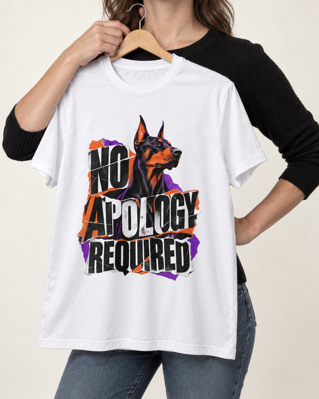 Doberman No Apology Required Torn Paper Graphic T-Shirt in White, held up on a hanger