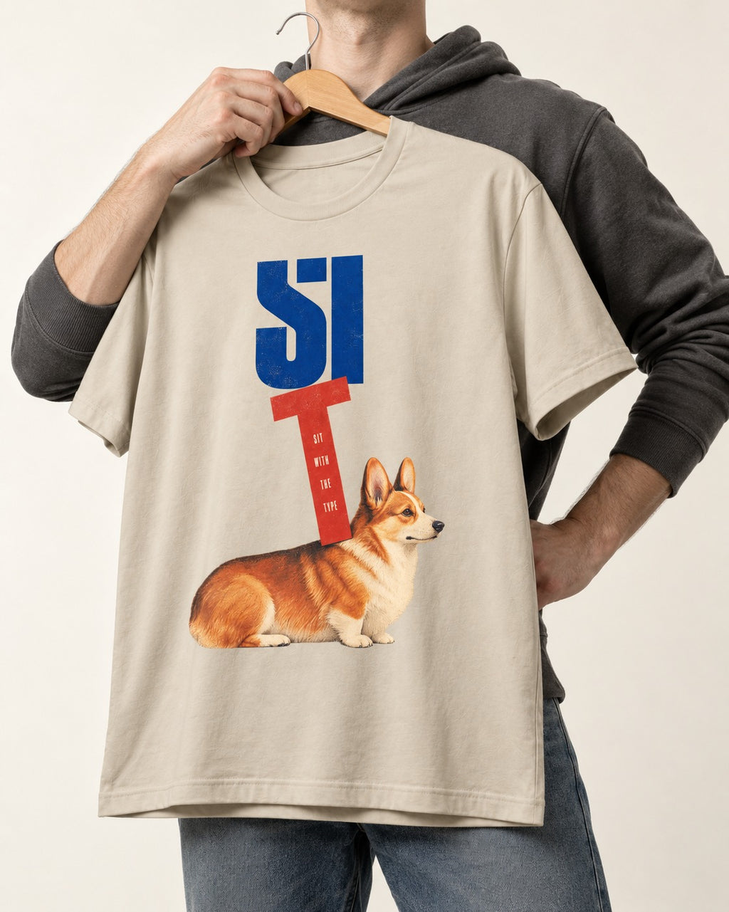Sit with the Corgi T-Shirt in Sand, held up on a hanger