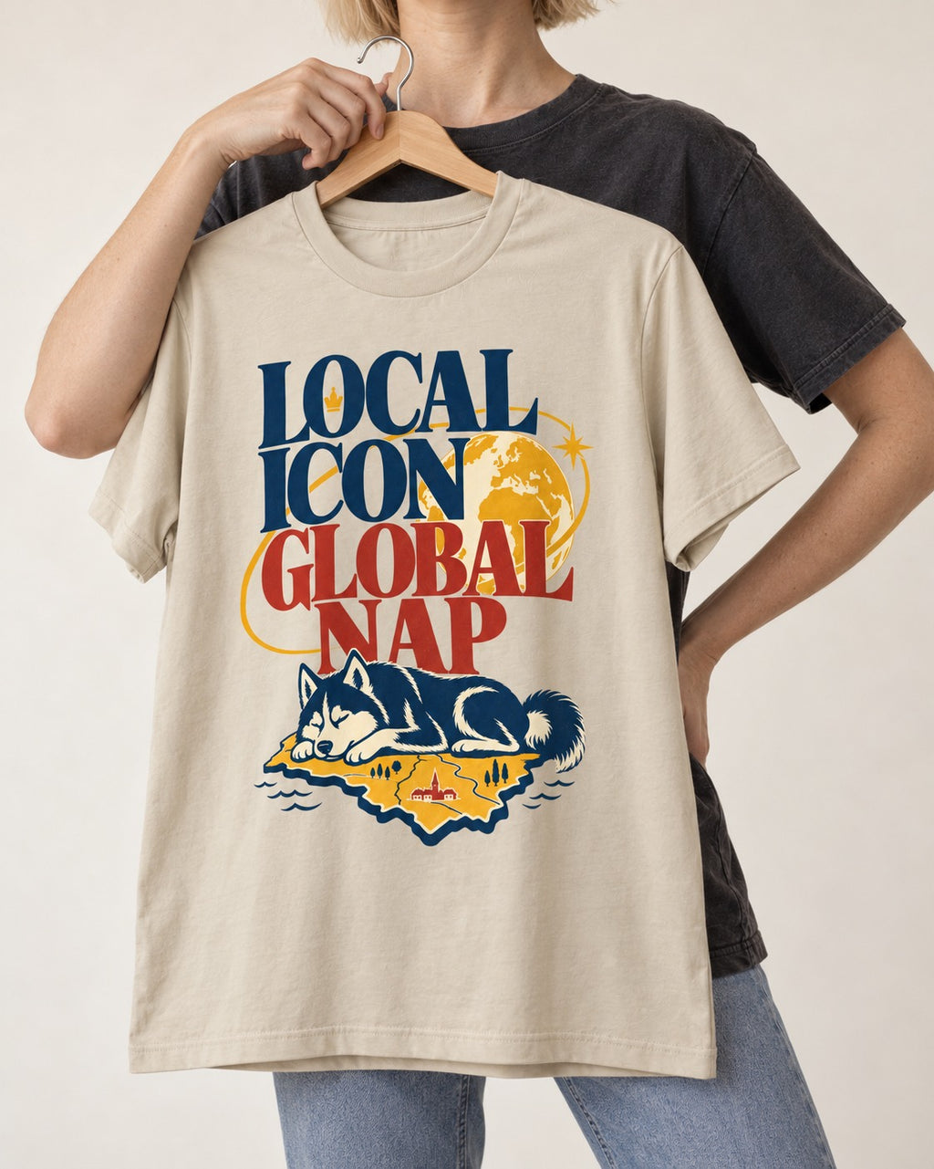 Husky Local Icon Global Nap T-Shirt in Sand, held up on a hanger