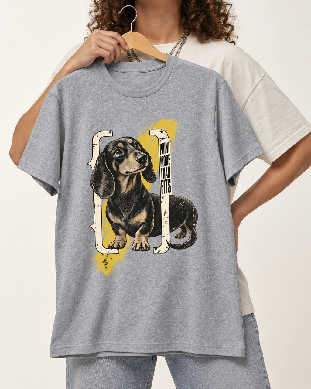 Dachshund More Than Fits T-Shirt in Sport Grey, held up on a hanger