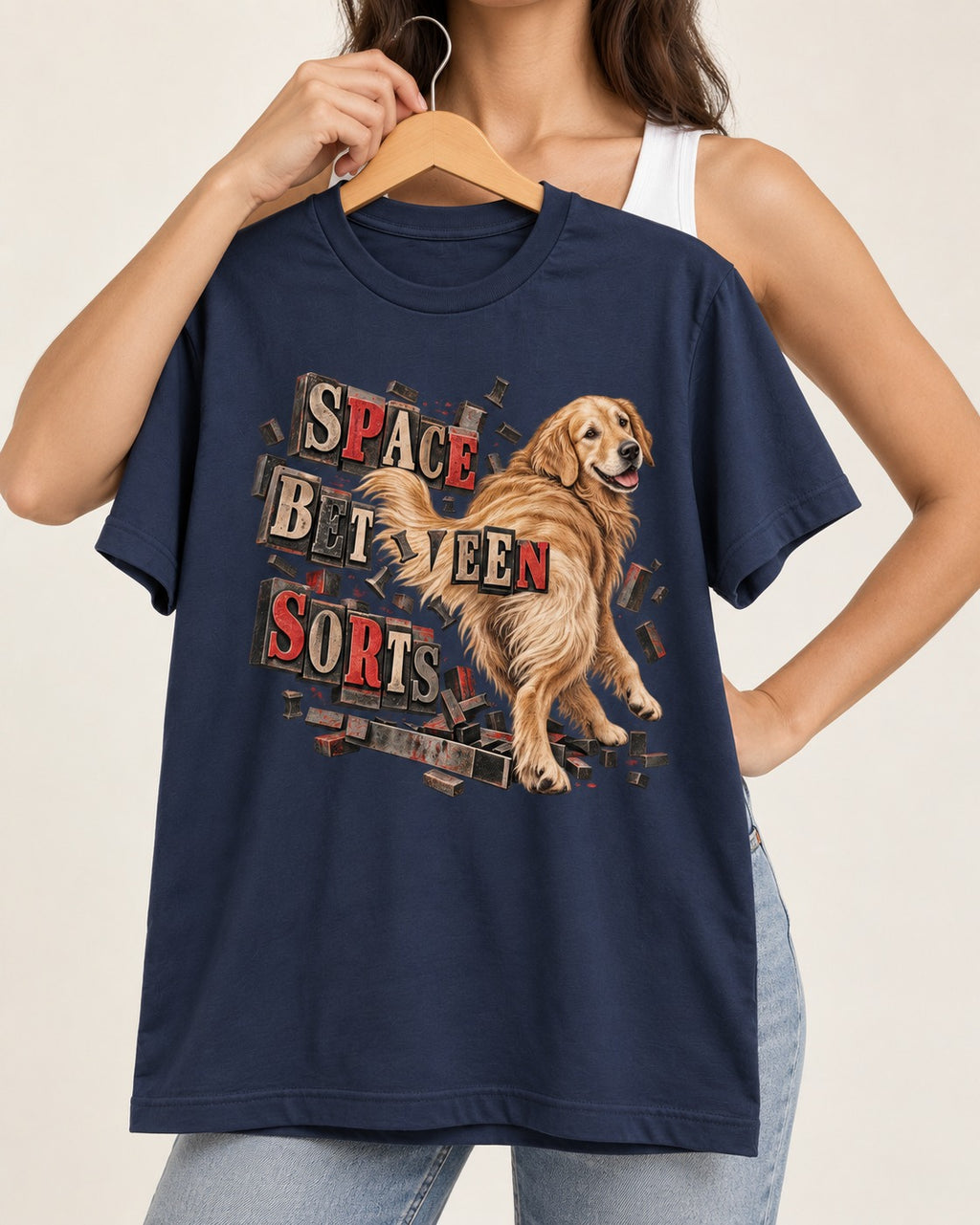 Golden Retriever Space Between Sorts Letterpress Graphic T-Shirt in Navy, held up on a hanger