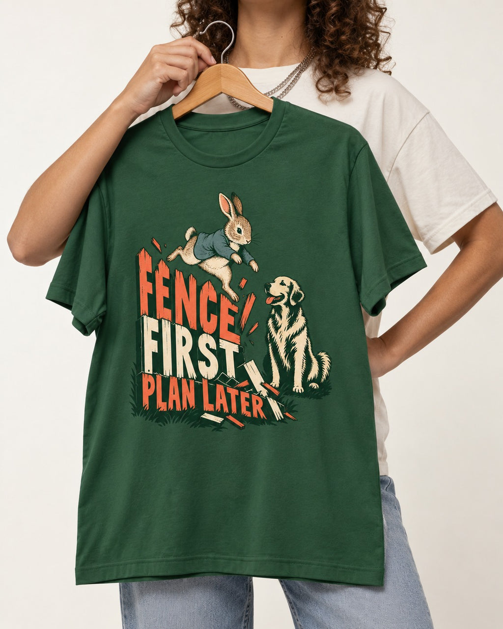 Golden Retriever Fence First Plan Later Rabbit Jump Graphic T-Shirt in Forest Green, held up on a hanger