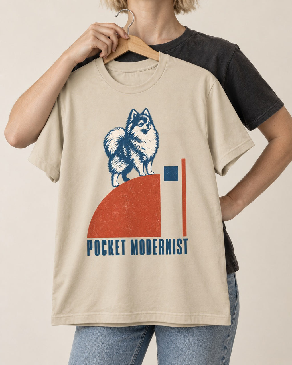 Pocket Modernist Pomeranian T-Shirt in Sand, held up on a hanger
