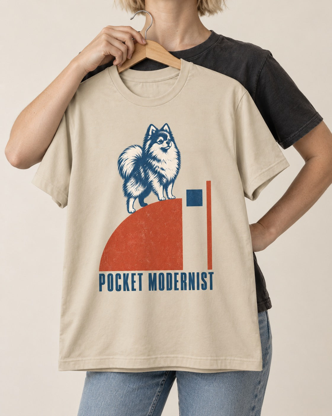Pocket Modernist Pomeranian T-Shirt in Sand, held up on a hanger