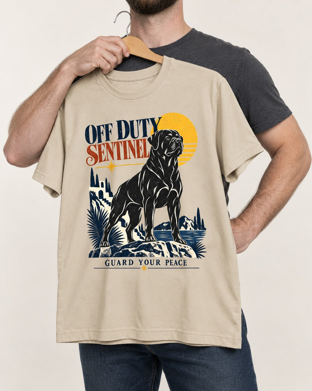 Off Duty Rottweiler Sentinel T-Shirt in Sand, held up on a hanger