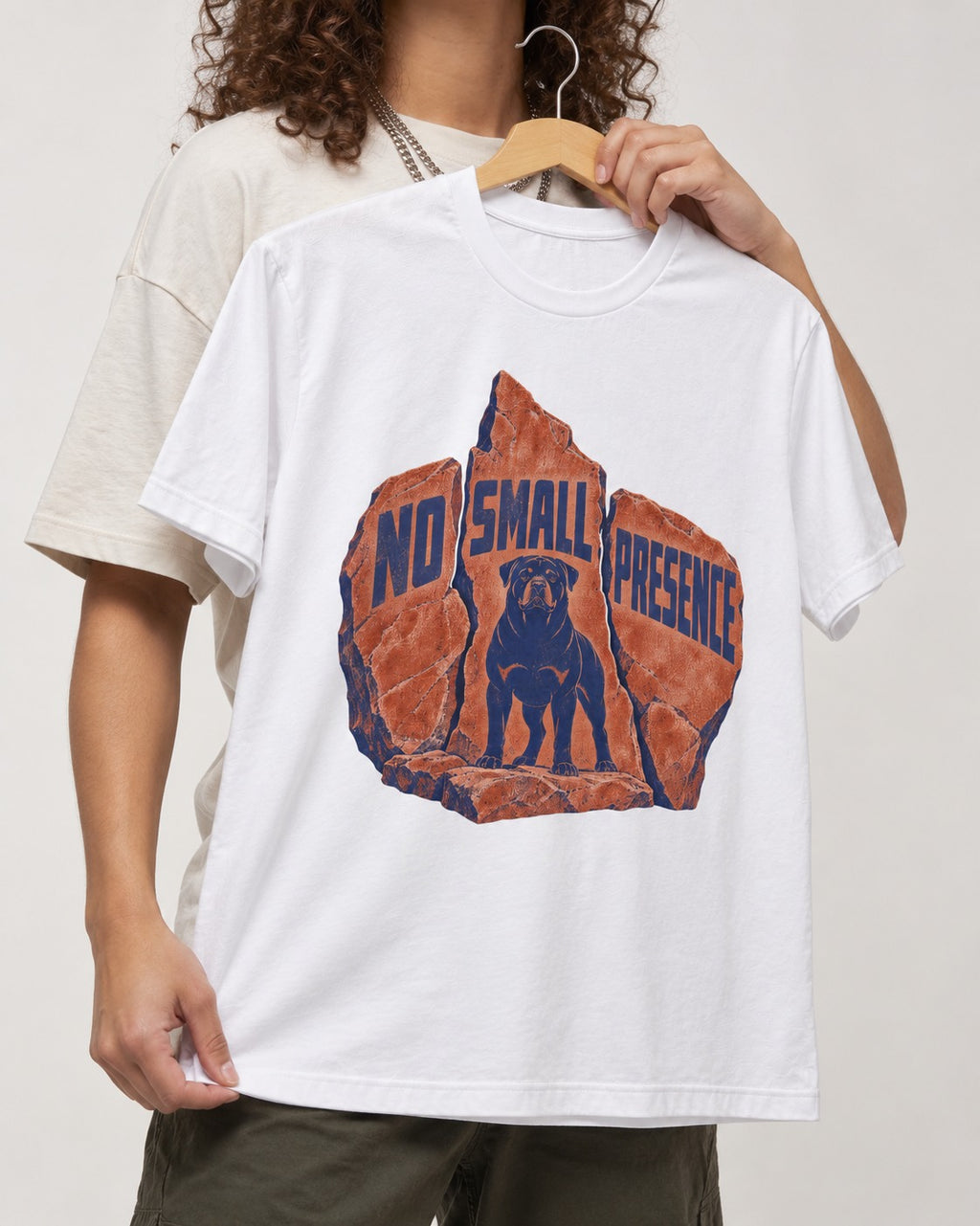 Rottweiler No Small Presence Monument Rock Graphic T-Shirt in White, held up on a hanger