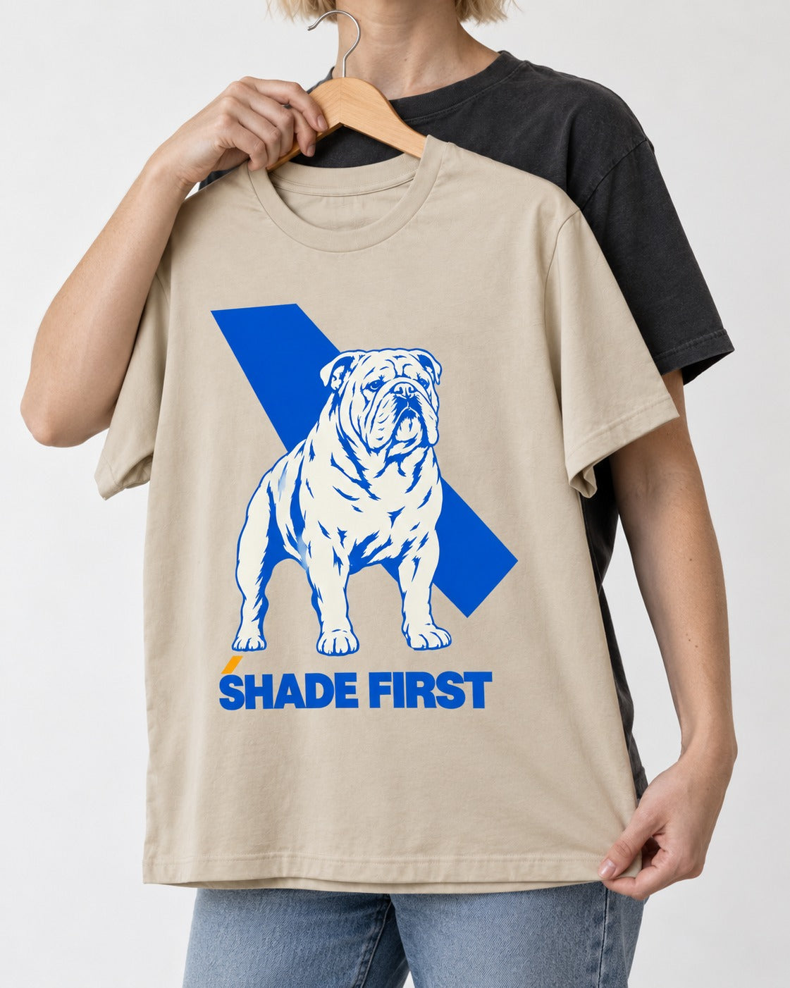 Shade First English Bulldog T-Shirt in Sand, held up on a hanger