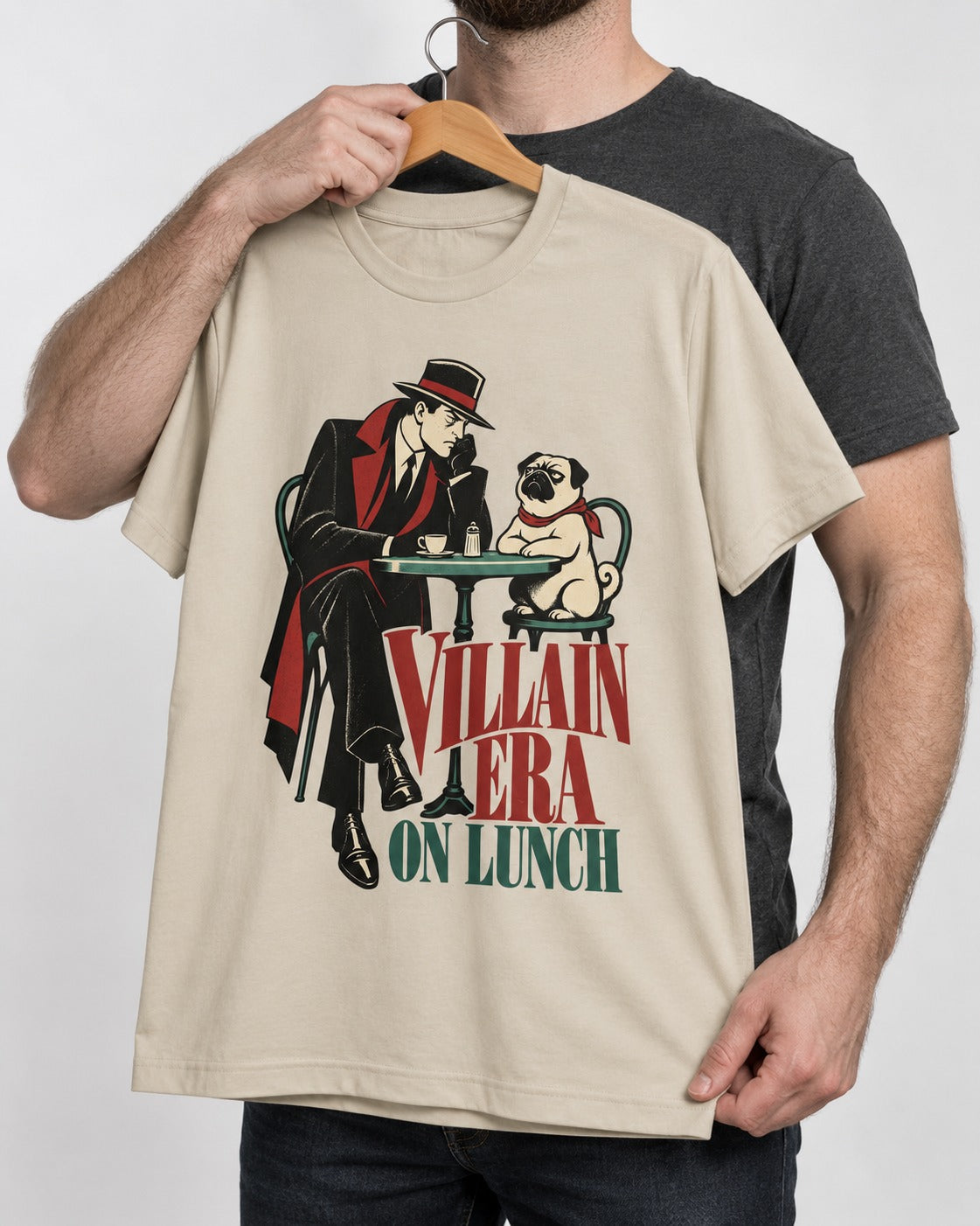 Pug Villain Era T-Shirt in Sand, held up on a hanger