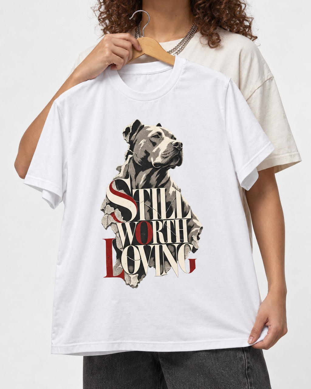 Pitbull Still Worth Loving Torn Poster Portrait Graphic T-Shirt in White, held up on a hanger