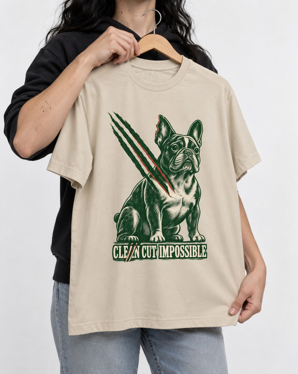 Frenchie Clean Cut Impossible T-Shirt in Sand, held up on a hanger