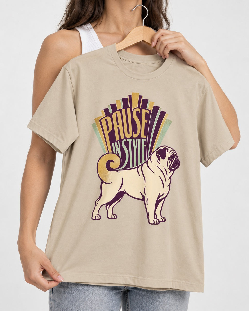 Pug Pause T-Shirt in Sand, held up on a hanger