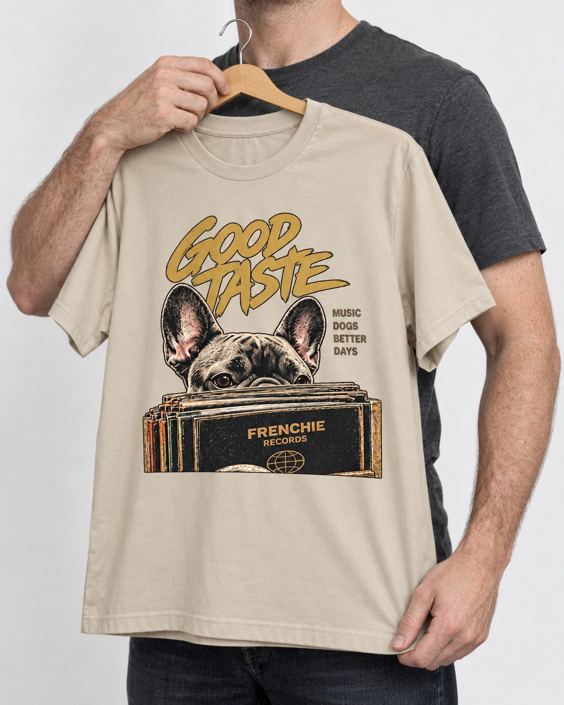 Frenchie's Good Taste T-Shirt in Sand, held up on a hanger