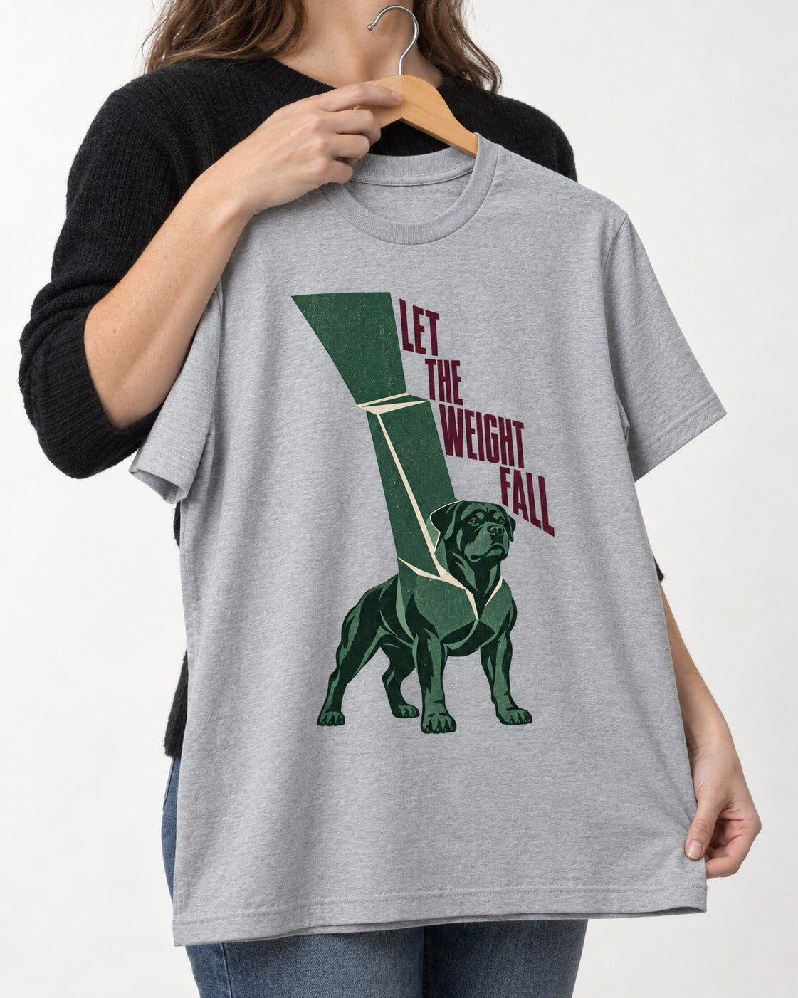 Let the Weight Fall Rottweiler T-Shirt in Sport Grey, held up on a hanger