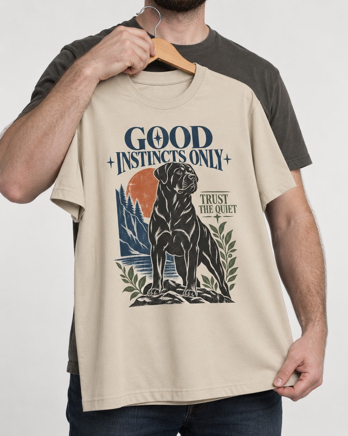 Good Instincts Only Rottweiler T-Shirt in Sand, held up on a hanger
