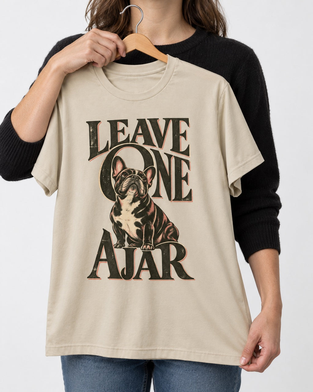 Leave One Ajar for Frenchie T-Shirt in Sand, held up on a hanger