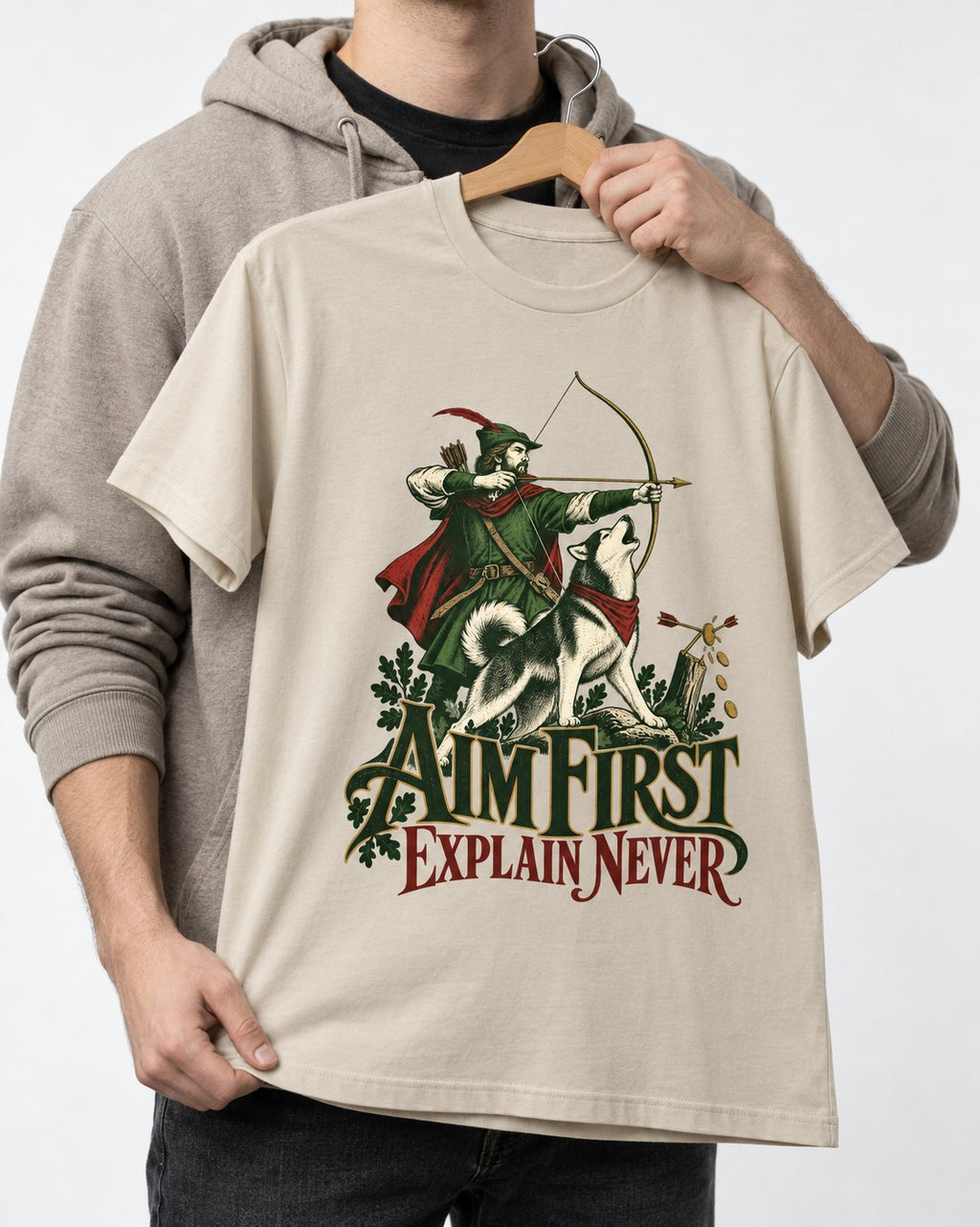 Husky Aim First Explain Never T-Shirt in Sand, held up on a hanger