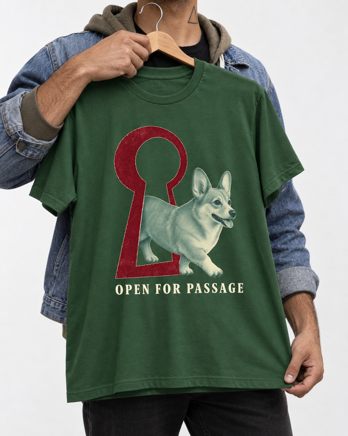 Corgi Open for Passage Keyhole Graphic T-Shirt in Forest Green, held up on a hanger