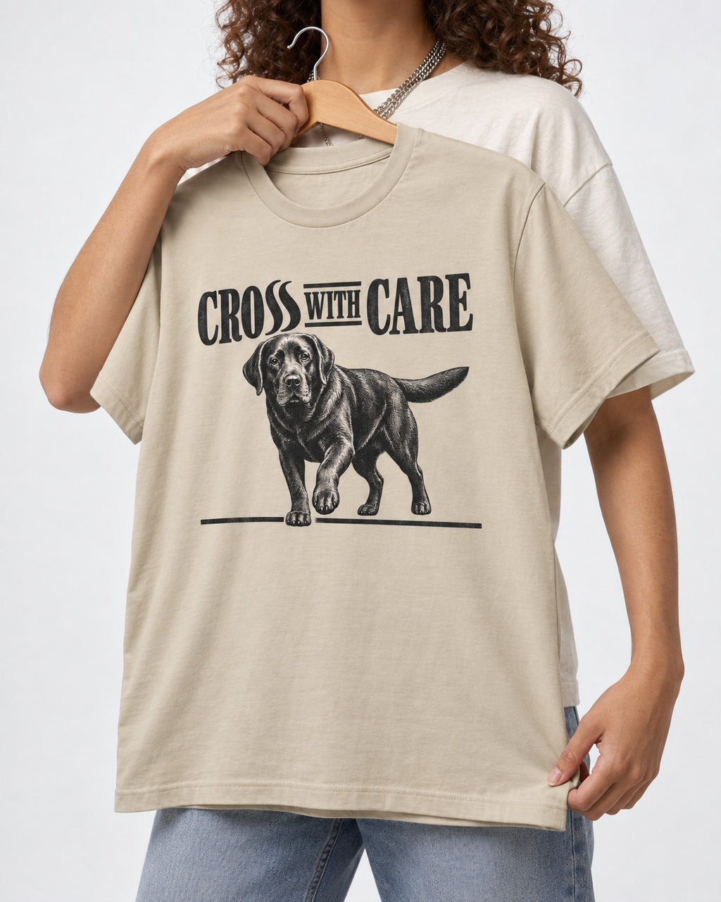 Labrador Retriever Cross with Care T-Shirt in Sand, held up on a hanger
