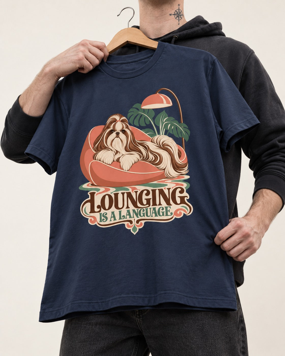 Shih Tzu Lounging Is a Language Retro Lounge Graphic T-Shirt in Navy, held up on a hanger