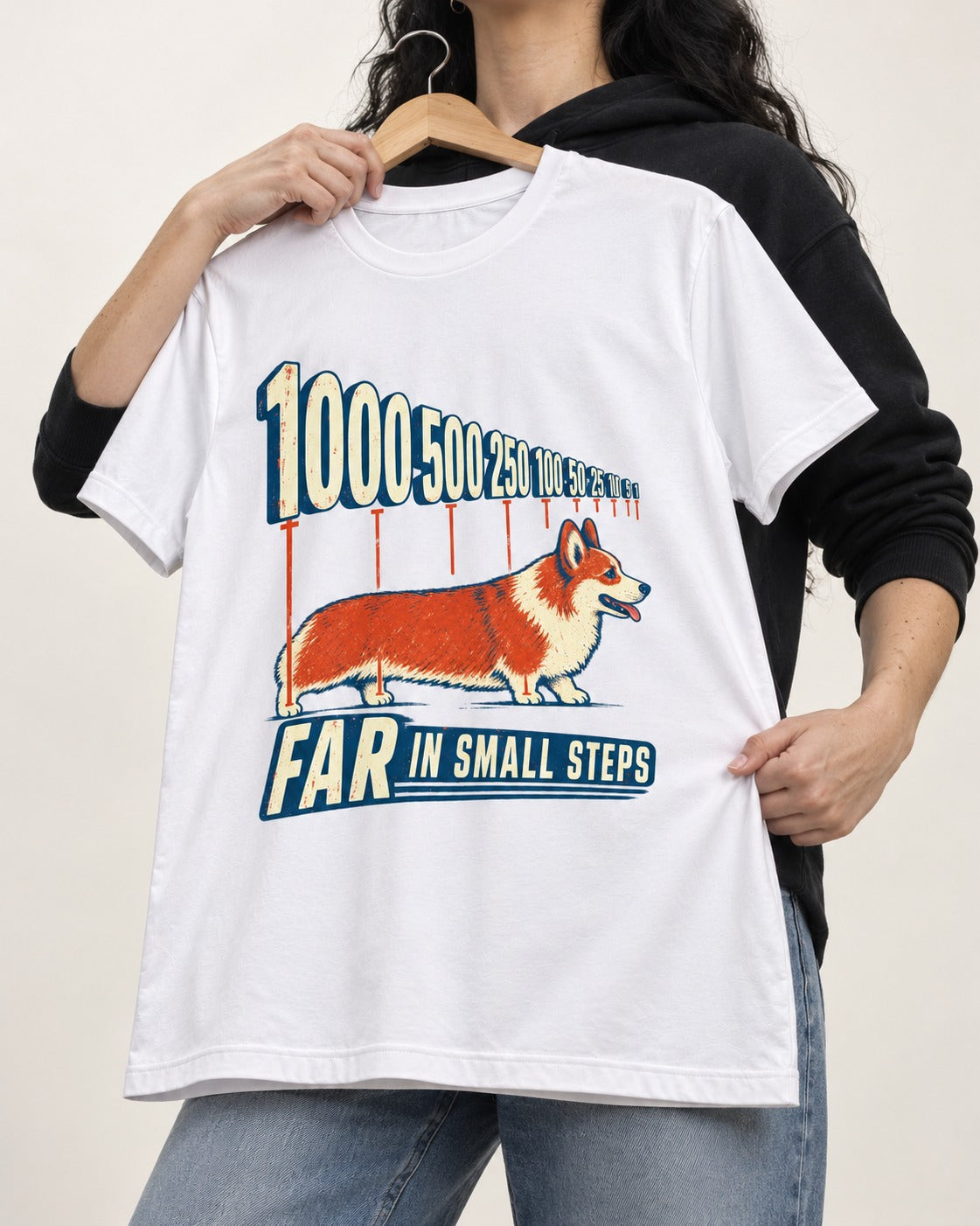 Corgi Far in Small Steps T-Shirt in White, held up on a hanger