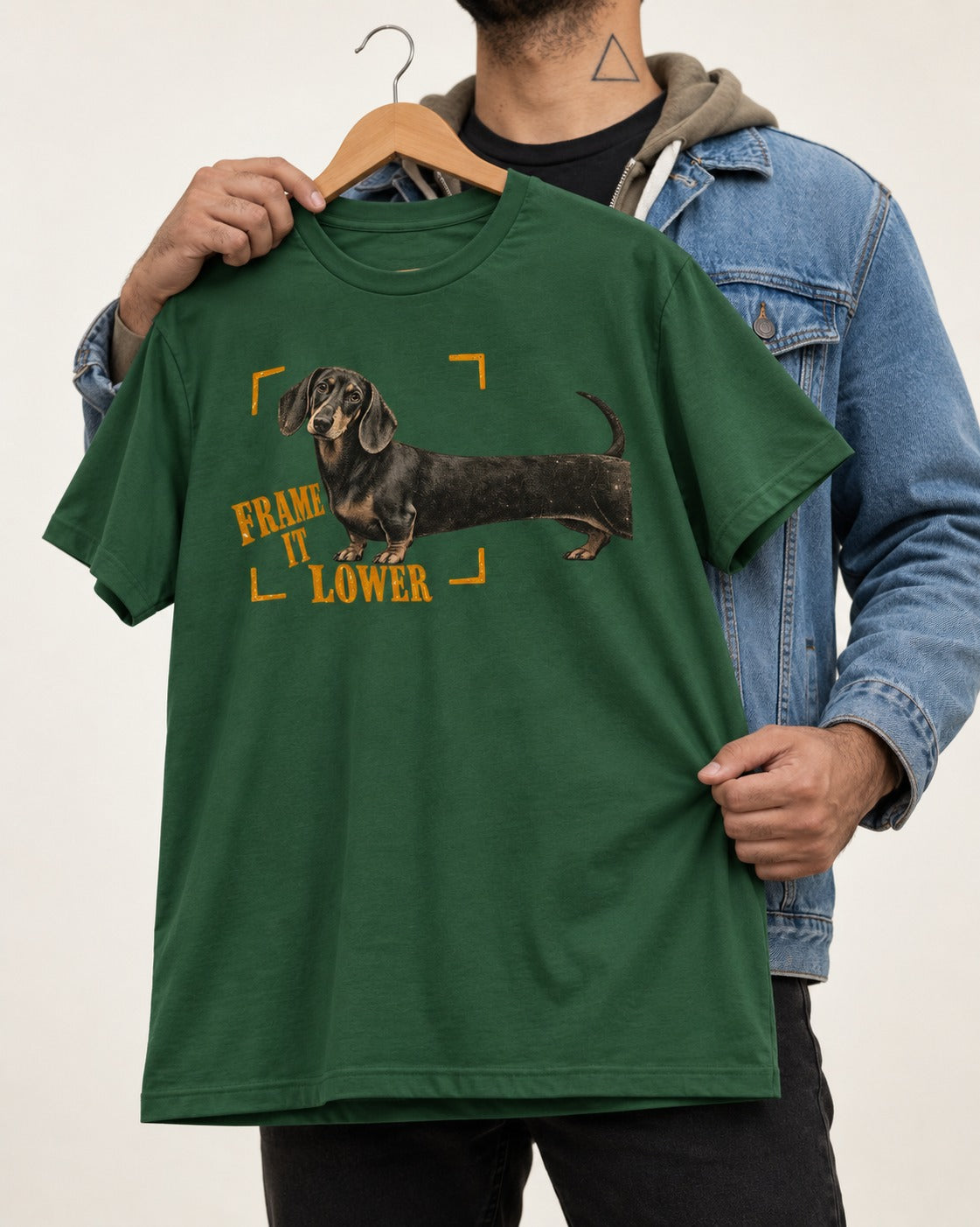 Dachshund Frame It Lower Viewfinder Graphic T-Shirt in Forest Green, held up on a hanger