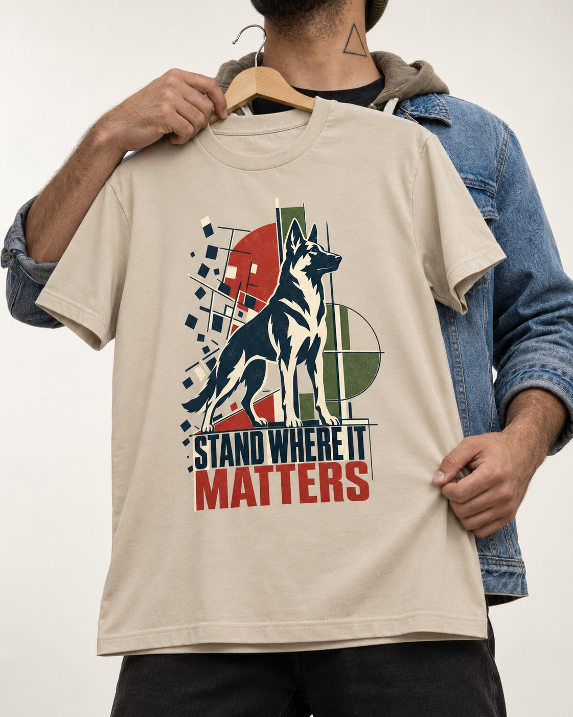 Stand Where It Matters German Shepherd Dog T-Shirt in Sand, held up on a hanger