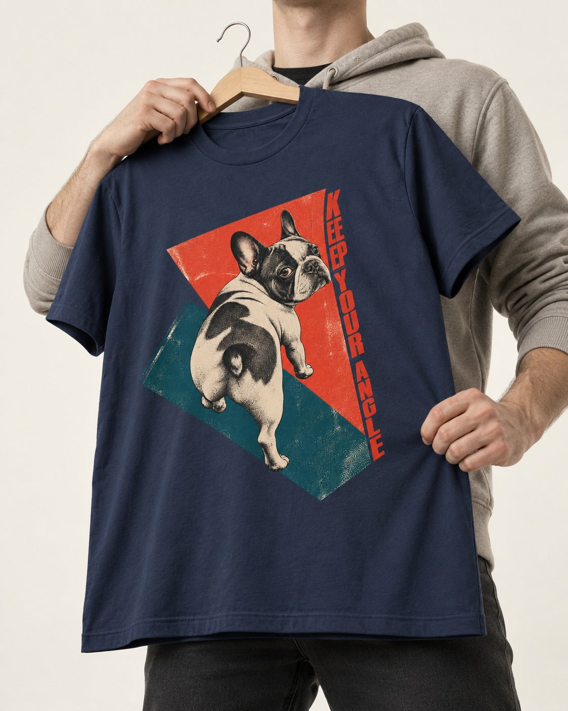 Frenchie Keep Your Angle Geometric Graphic T-Shirt in Navy, held up on a hanger