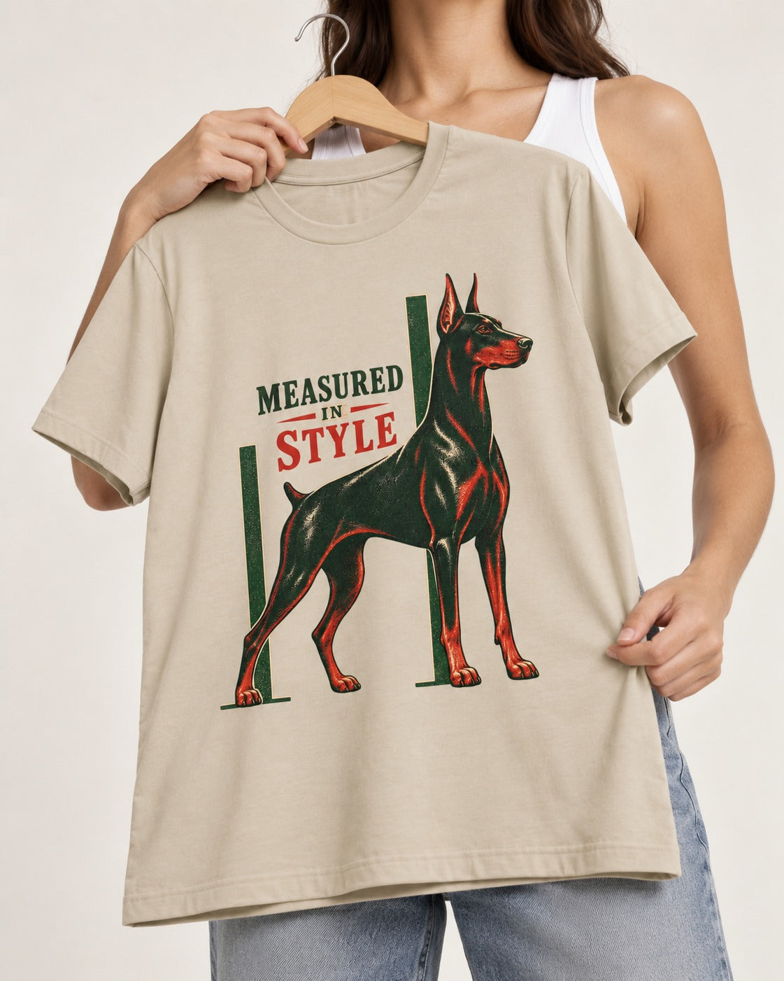 Measured in Doberman T-Shirt in Sand, held up on a hanger