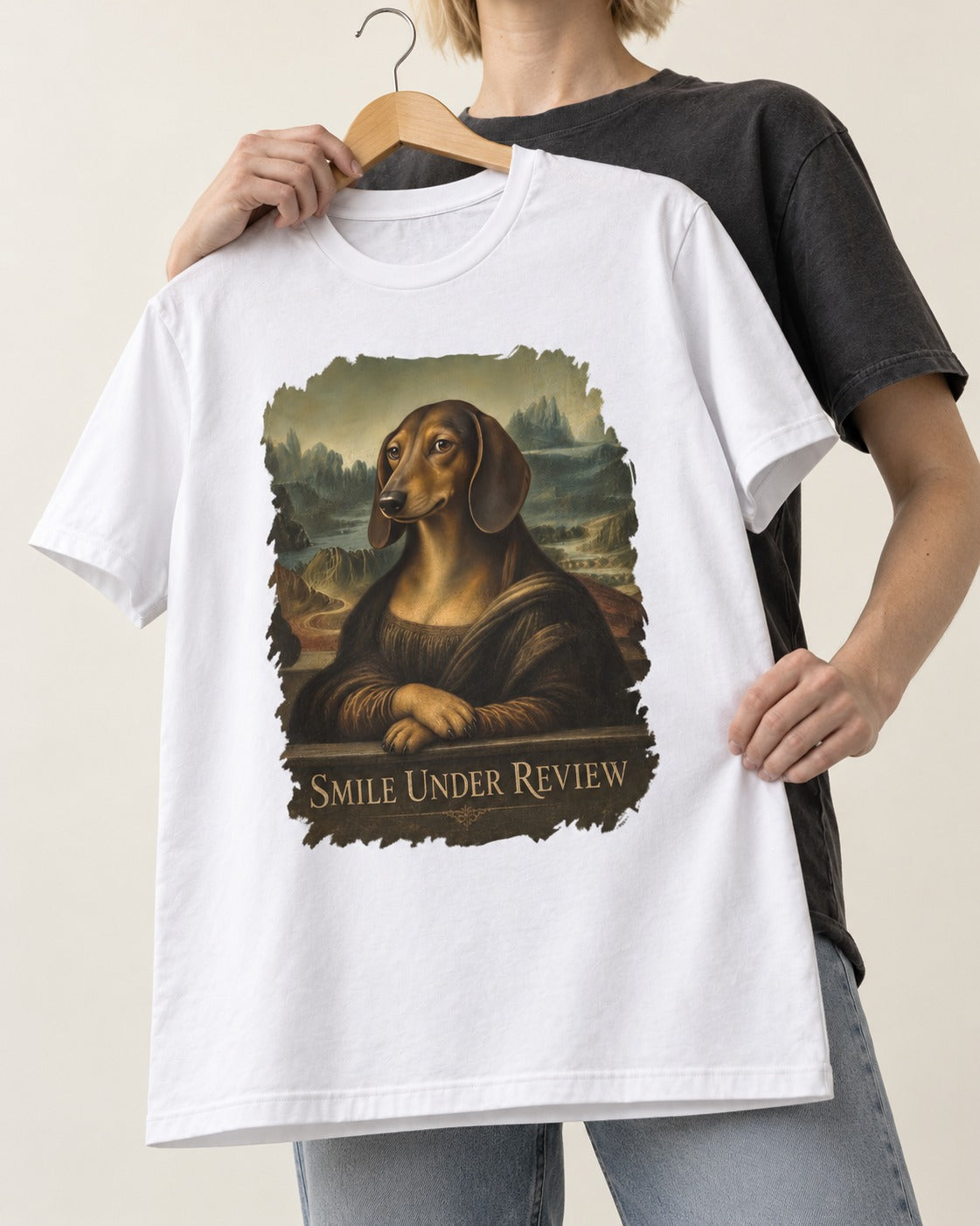 Dachshund Smile Under Review Mona Lisa Graphic T-Shirt in White, held up on a hanger