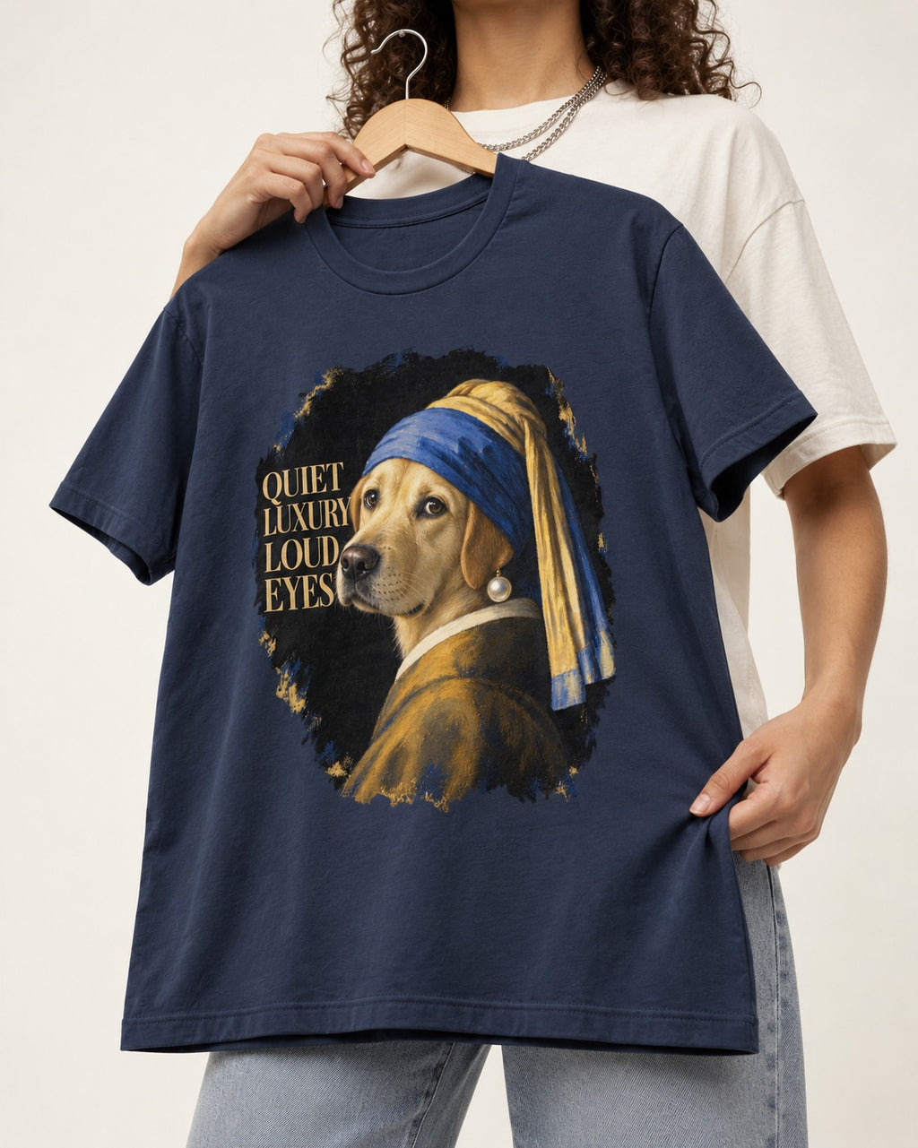 Labrador Retriever Quiet Luxury Loud Eyes Pearl Earring Graphic T-Shirt in Navy, held up on a hanger