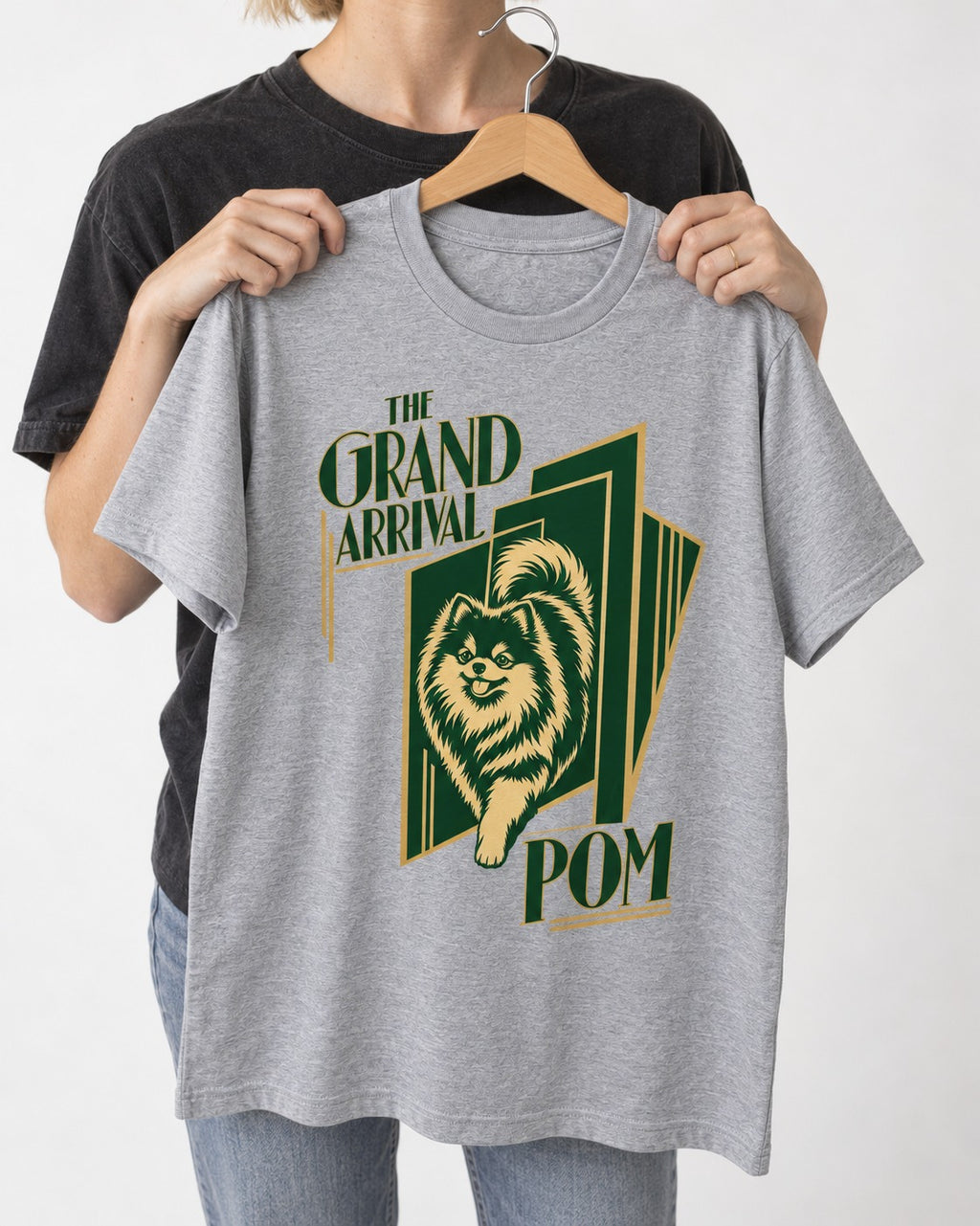 The Grand Arrival Pomeranian T-Shirt in Sport Grey, held up on a hanger