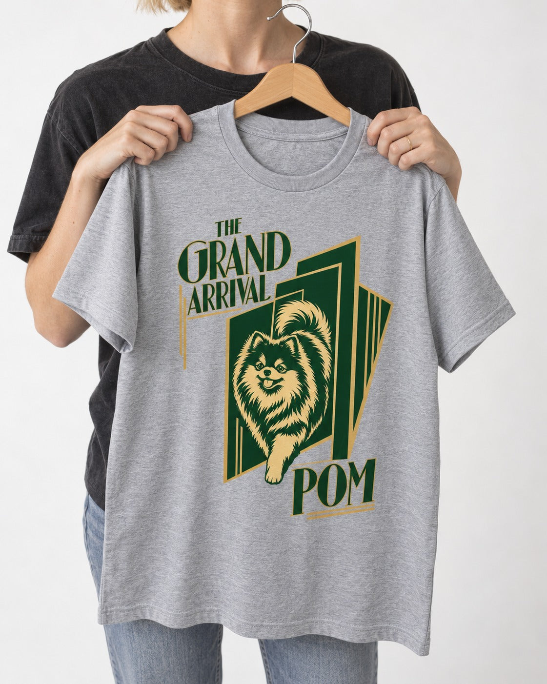 The Grand Arrival Pomeranian T-Shirt in Sport Grey, held up on a hanger
