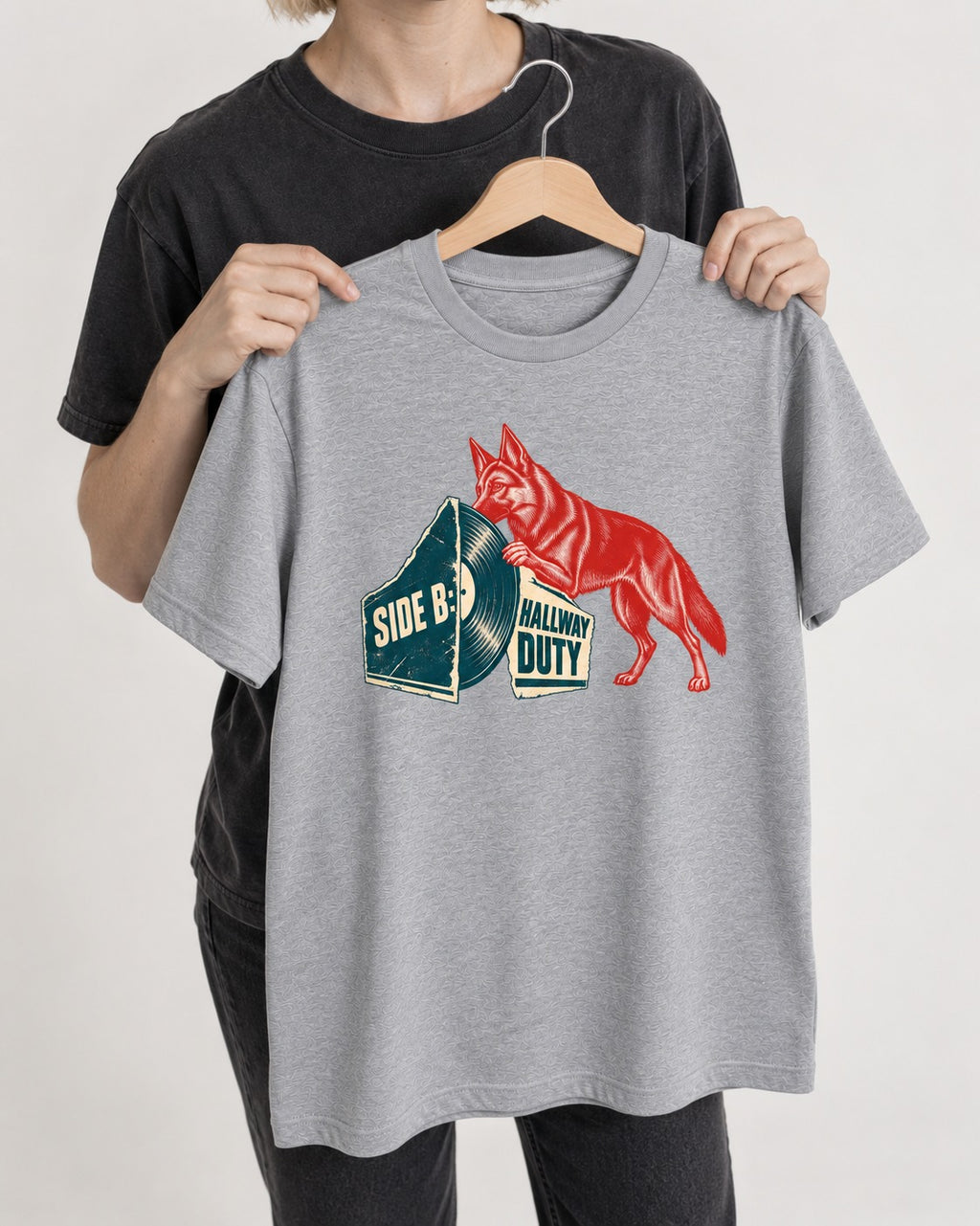 Side B Hallway Duty Vinyl Record German Shepherd Dog Graphic T-Shirt in Sport Grey, held up on a hanger