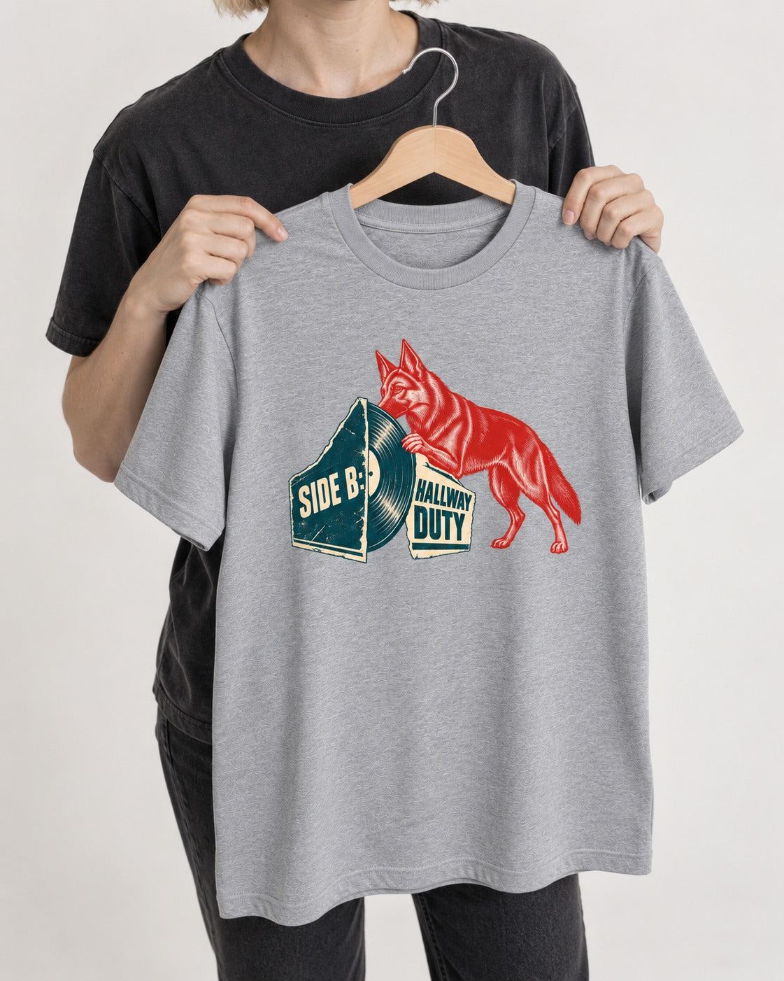 Side B Hallway Duty Vinyl Record German Shepherd Dog Graphic T-Shirt in Sport Grey, held up on a hanger