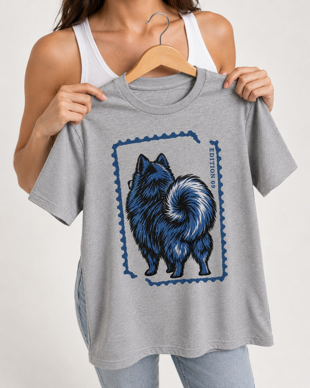 Pomeranian Pride T-Shirt in Sport Grey, held up on a hanger