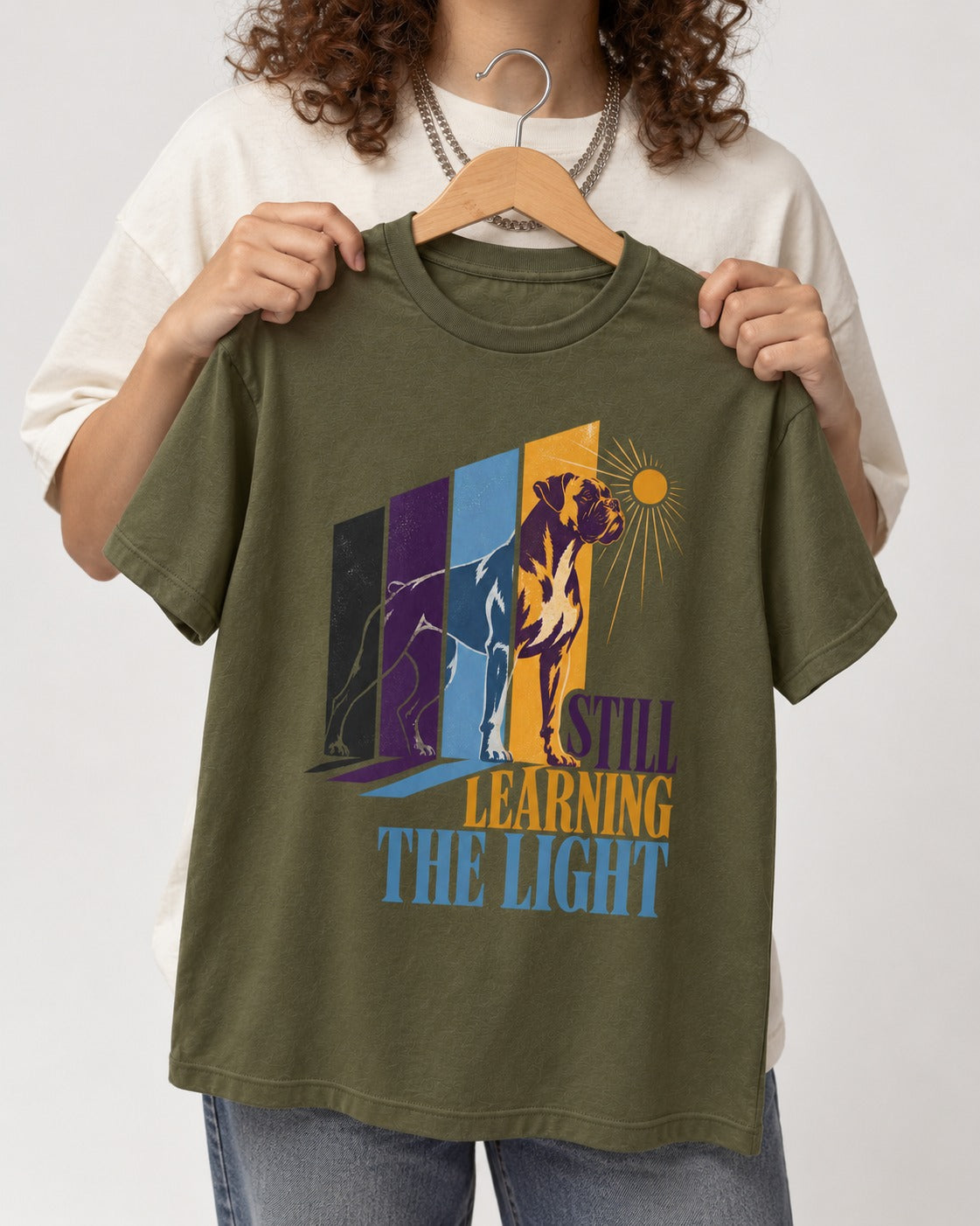 Still Learning the Light Boxer Doorway Progression Graphic T-Shirt in Heather Military Green, held up on a hanger