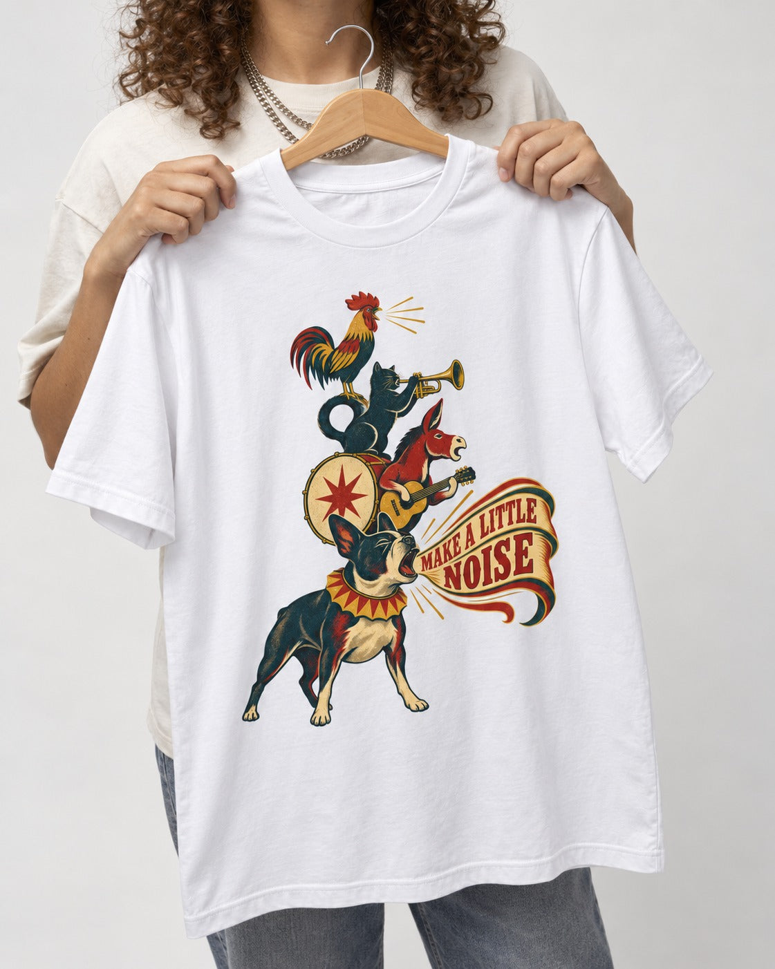 Boston Terrier Make A Little Noise T-Shirt in White, held up on a hanger