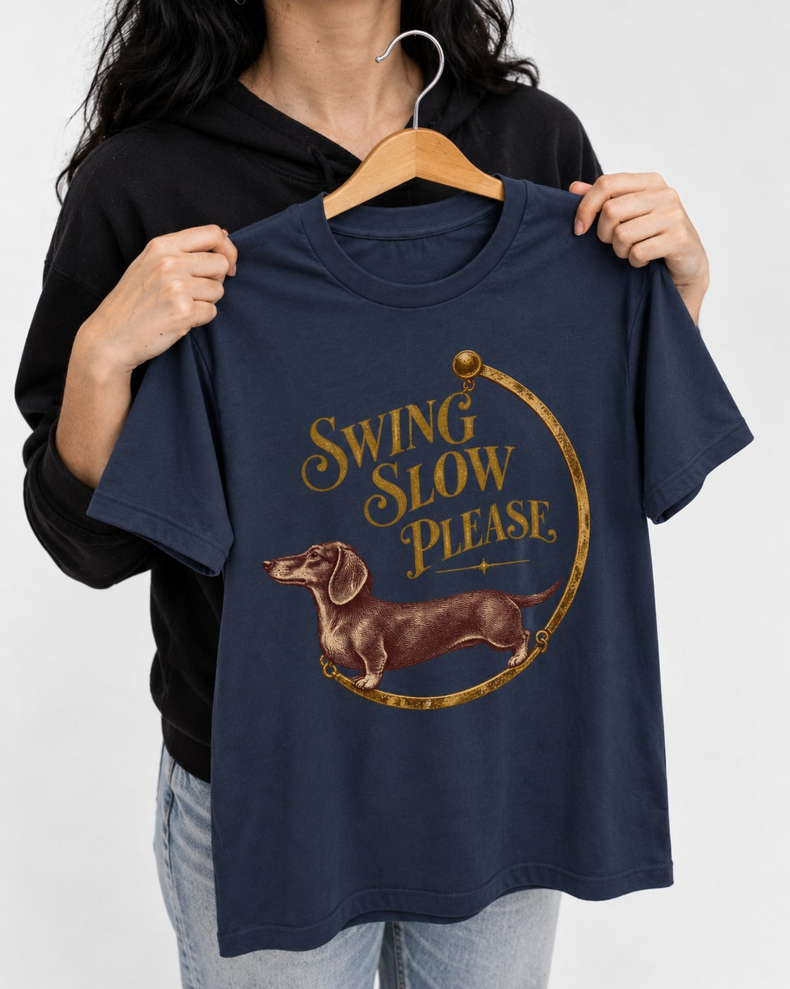 Dachshund Swing Slow Please Necklace Frame Graphic T-Shirt in Navy, held up on a hanger